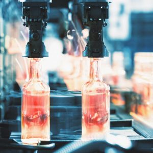 Hot glass bottles on the factory conveyor